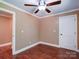 Well-lit bedroom with hardwood flooring, one window, a door to the left and a ceiling fan at 1306 Abbey Ct, Lancaster, SC 29720