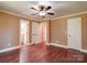 A cozy bedroom with neutral walls, hardwood floors, and a ceiling fan at 1306 Abbey Ct, Lancaster, SC 29720
