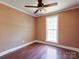 Cozy bedroom featuring hardwood floors, a ceiling fan, fresh paint and a window at 1306 Abbey Ct, Lancaster, SC 29720