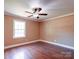 Bright bedroom featuring hardwood floors, fresh paint, a ceiling fan and a window at 1306 Abbey Ct, Lancaster, SC 29720