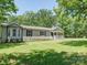 A beautiful home with a covered porch sits on a well-maintained, lush green lawn at 1306 Abbey Ct, Lancaster, SC 29720