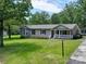 Charming one-story home with manicured lawn, white picket fence, and welcoming front porch at 1306 Abbey Ct, Lancaster, SC 29720