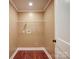 Small laundry room with hardwood floor and a wire shelf above hookups at 1306 Abbey Ct, Lancaster, SC 29720