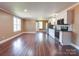 Open living area features hardwood floors and updated kitchen with stainless steel appliances at 1306 Abbey Ct, Lancaster, SC 29720