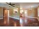 Open-concept living room features hardwood floors, ceiling fan, and seamless transition to a modern kitchen at 1306 Abbey Ct, Lancaster, SC 29720