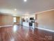 Spacious living room with hardwood flooring and a view of the stainless steel kitchen appliances at 1306 Abbey Ct, Lancaster, SC 29720