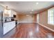 Hardwood floor expansive living area with stainless steel kitchen and bright natural light at 1306 Abbey Ct, Lancaster, SC 29720