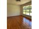 This simple bedroom features hardwood floors and a large window at 1412 Beverly Ave, Shelby, NC 28152
