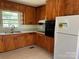 Cozy kitchen with wood cabinets and white refrigerator at 1412 Beverly Ave, Shelby, NC 28152