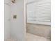 Modern bathroom features gold hardware, white tile, pebble floor, and plantation shutters at 15 Old Stage Trl, Clover, SC 29710