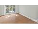 Bright bedroom featuring natural light, wood-look tile floors, and large windows at 15 Old Stage Trl, Clover, SC 29710