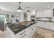 Modern kitchen with island cooktop, stainless appliances, and access to lake view dining at 15 Old Stage Trl, Clover, SC 29710