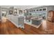 Spacious living room with hardwood floors, a fireplace, and expansive views of the lake at 15 Old Stage Trl, Clover, SC 29710