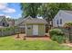 Backyard with green outbuilding and manicured landscaping at 1500 Lynway Dr, Charlotte, NC 28203