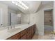 Bathroom features a double vanity, large mirror, and tiled shower/tub, exuding functionality and style at 1500 Lynway Dr, Charlotte, NC 28203
