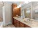 Bathroom featuring a double vanity with framed mirror and separate tub with shower at 1500 Lynway Dr, Charlotte, NC 28203