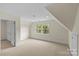 Large bedroom with neutral carpeting, a window, and multiple closets, provides ample space at 1500 Lynway Dr, Charlotte, NC 28203