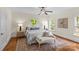 Bright bedroom with hardwood floors, sitting bench, ceiling fan, and natural light at 1500 Lynway Dr, Charlotte, NC 28203