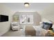 Staged bedroom features natural light, a comfortable chair, and calming decor, creating a relaxing retreat at 1500 Lynway Dr, Charlotte, NC 28203