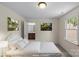 Staged bedroom includes a large bed, decor, and access to a bathroom at 1500 Lynway Dr, Charlotte, NC 28203