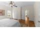 Spacious bedroom featuring hardwood floors, ceiling fan, and access to other rooms in the home at 1500 Lynway Dr, Charlotte, NC 28203