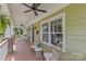 Inviting front porch with a ceiling fan, comfortable seating and views of the landscaped front yard at 1500 Lynway Dr, Charlotte, NC 28203