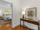 Stylish hallway leading to a bedroom, features hardwood floors and decorative console table at 1500 Lynway Dr, Charlotte, NC 28203