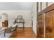 Bright living room with hardwood floors, a console table, and an open doorway at 1500 Lynway Dr, Charlotte, NC 28203