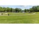 A beautiful park featuring manicured lawns, a lake, and walking paths at 1500 Lynway Dr, Charlotte, NC 28203