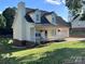 Delightful home with a cozy front porch, chimney, and well-maintained lawn at 1505 Wimbleton Woods Dr # 5, Fort Mill, SC 29708