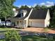 Inviting home featuring a lovely front porch, manicured lawn, and an attached garage at 1505 Wimbleton Woods Dr # 5, Fort Mill, SC 29708