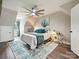 Bright main bedroom featuring a ceiling fan, blue accent wall, and a comfortable bed at 1505 Wimbleton Woods Dr # 5, Fort Mill, SC 29708