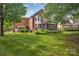 Expansive backyard features lush lawn, mature trees, a screened porch, and a deck perfect for outdoor enjoyment at 15737 Agincourt Dr, Huntersville, NC 28078