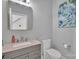 Powder room with a pink marble sink, framed mirror, and neutral colored walls and floors at 15737 Agincourt Dr, Huntersville, NC 28078