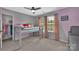 Bright bedroom features a bunk bed, neutral carpet, ceiling fan, and natural light from the large windows at 15737 Agincourt Dr, Huntersville, NC 28078