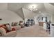 Bright bonus room featuring a seating area and multiple desks, ideal for a versatile living or work space at 15737 Agincourt Dr, Huntersville, NC 28078