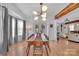 Inviting dining room with a long wood table, modern lighting, and open access to the living space at 15737 Agincourt Dr, Huntersville, NC 28078