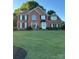 Traditional brick two-story home with well-manicured lawn and black shutters at 15737 Agincourt Dr, Huntersville, NC 28078