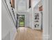 Bright foyer features hardwood floors, a staircase, and built-in shelving at 15737 Agincourt Dr, Huntersville, NC 28078