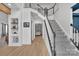 Spacious foyer featuring hardwood floors, stairs, and a view into the living room at 15737 Agincourt Dr, Huntersville, NC 28078