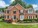 Charming two-story brick home with black shutters, landscaped front yard, and a welcoming entrance at 15737 Agincourt Dr, Huntersville, NC 28078