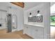 Bright hallway with built-in white cabinets, wood floors, and decorative wall art at 15737 Agincourt Dr, Huntersville, NC 28078