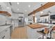 Bright, open kitchen with wood island, white cabinets, and stainless steel appliances at 15737 Agincourt Dr, Huntersville, NC 28078