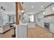 Modern, open kitchen with white cabinets, wood counters, stainless appliances, and counter seating at 15737 Agincourt Dr, Huntersville, NC 28078