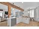 Open kitchen with white cabinets, a breakfast bar, stainless appliances, and connection to the living area at 15737 Agincourt Dr, Huntersville, NC 28078