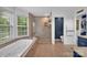 Bathroom featuring a soaking tub, glass enclosed shower, and granite counters at 15737 Agincourt Dr, Huntersville, NC 28078