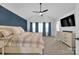 Spacious bedroom with a ceiling fan, dresser, and a large bed with side tables at 15737 Agincourt Dr, Huntersville, NC 28078