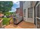 Outdoor kitchen on wooden deck offers modern grill, built in storage, and a cozy space for entertainment at 15737 Agincourt Dr, Huntersville, NC 28078
