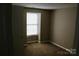 Cozy bedroom with carpet flooring and a large window at 1604 Arlyn Cir # E, Charlotte, NC 28213