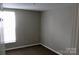 Cozy carpeted bedroom with neutral walls and window at 1604 Arlyn Cir # E, Charlotte, NC 28213